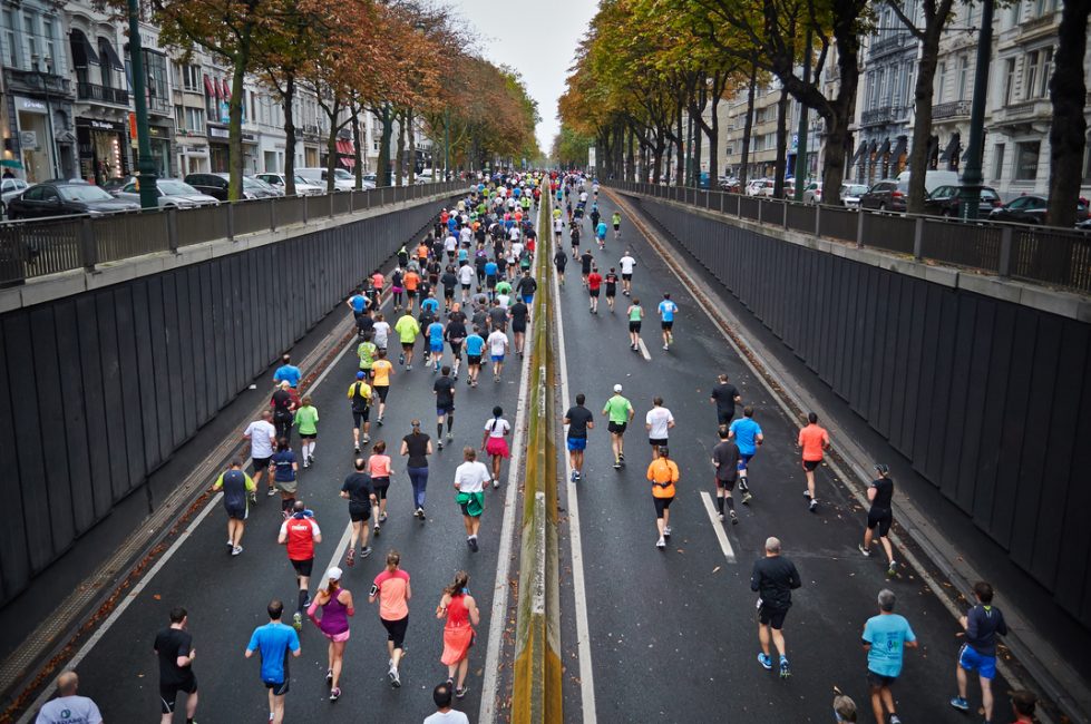 Runners running up a street hill.