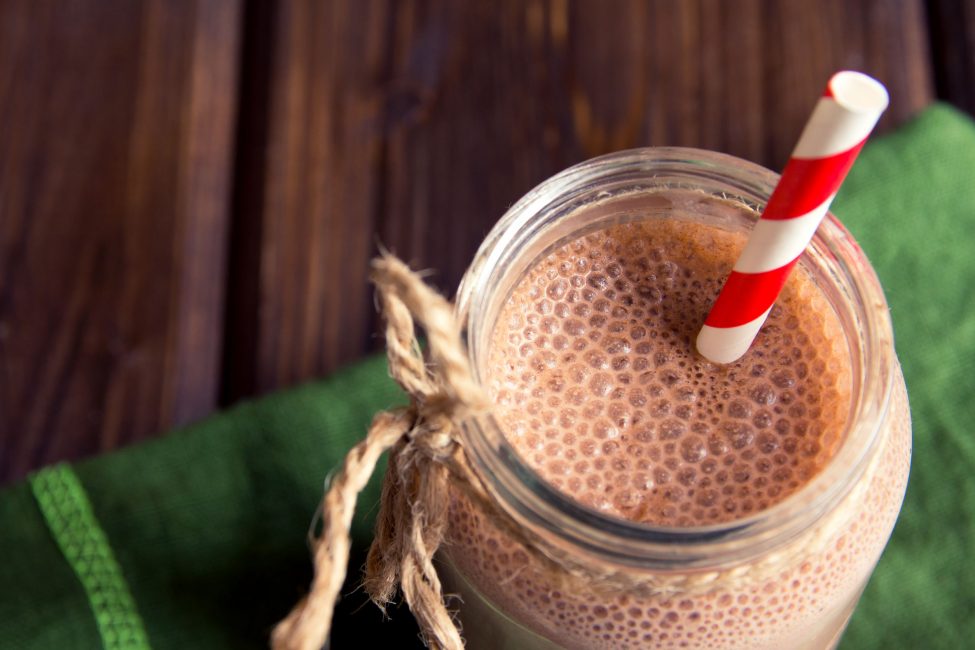 chocolate smoothie in jar with straw