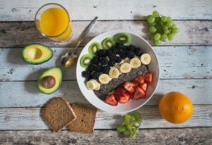 plate of fruits with toast and avocado
