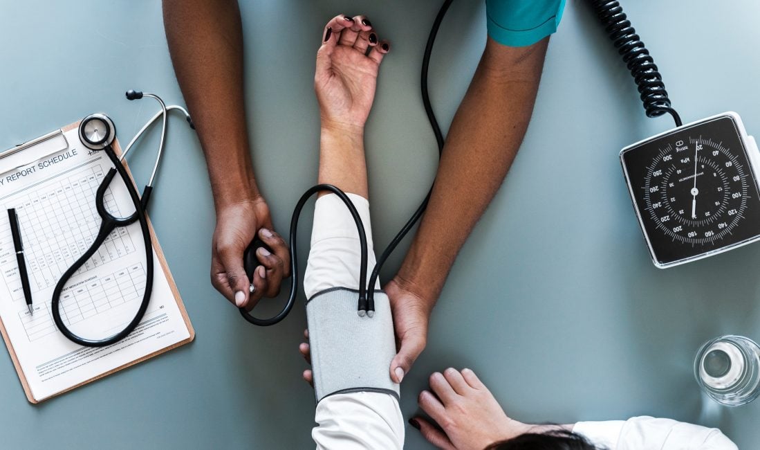 doctor checking patient's blood pressure