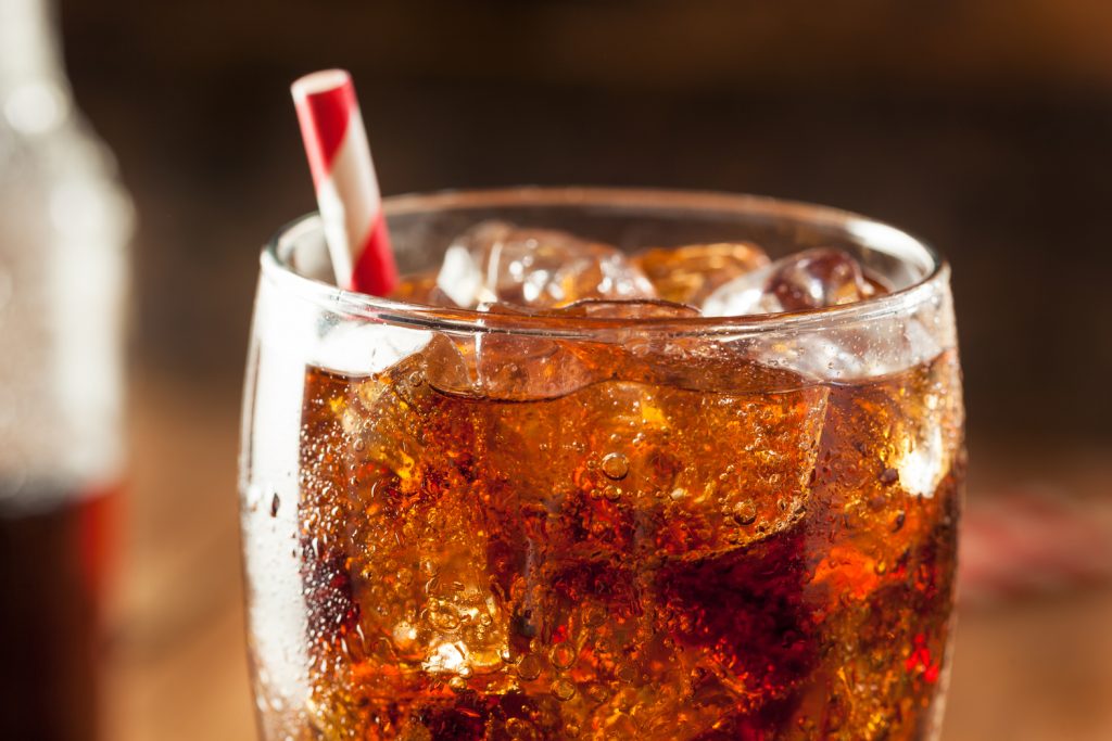 fountain soda in a glass with a straw