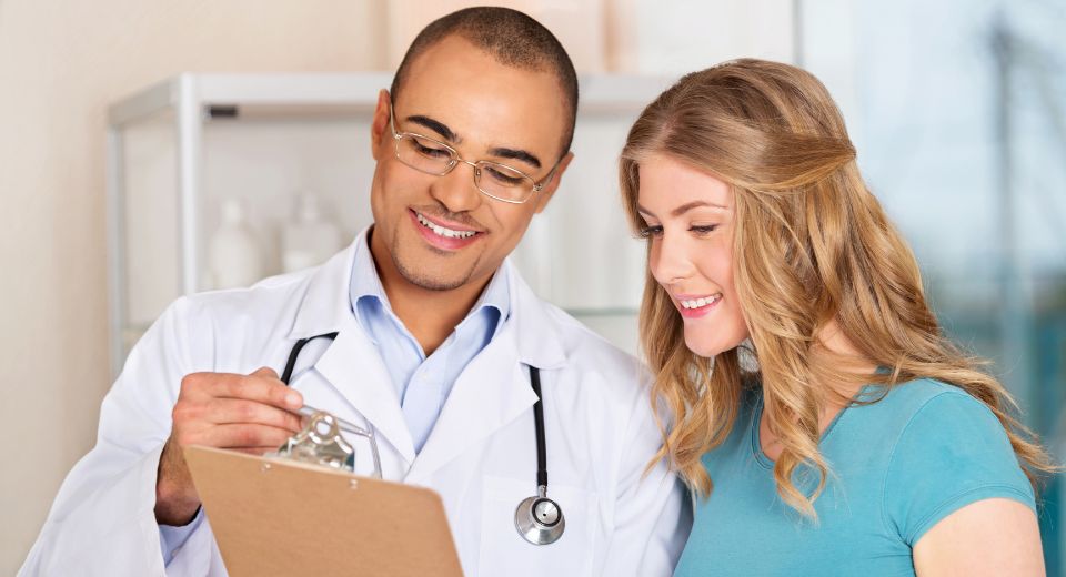 Doctor talking to women patient about an annual check-up, health and wellness.