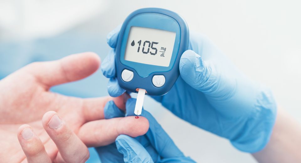 Nurse checking diabetes levels of a patient